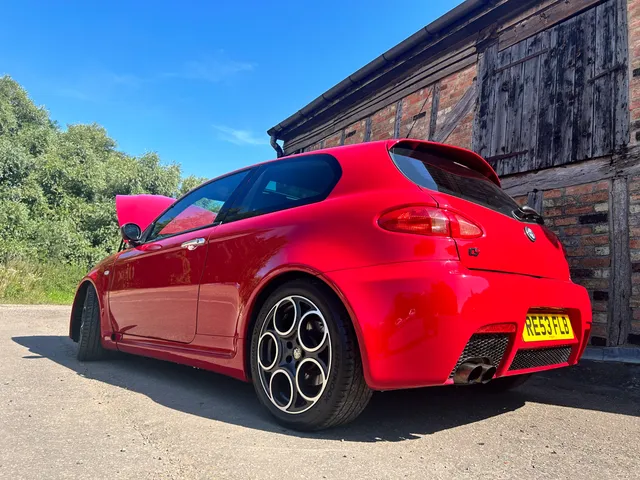 A red Alfa Romeo 147 GTA from the rear