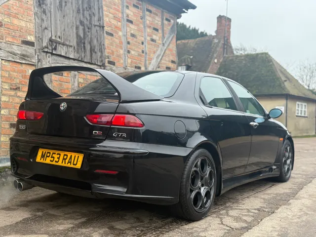 A black Alfa Romeo 156 GTA from the rear