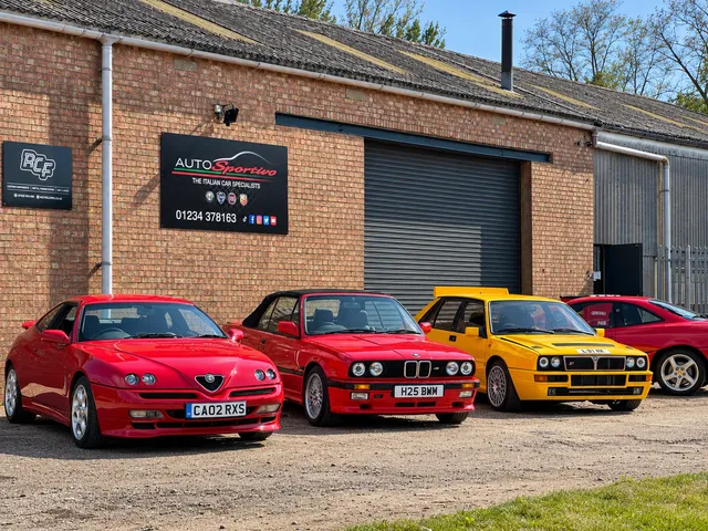 Alfa Romeo, a red coupe and a yellow Lancia Delta Integrale on the forecourt